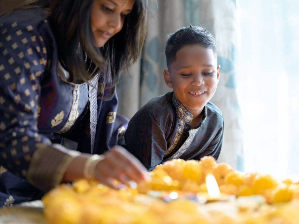 Mother and son celebrate Diwali, reflecting the impact of customer-centricity in the consumer packaged goods industry.