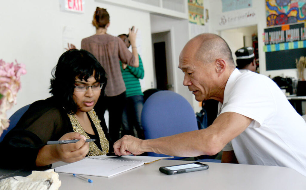 A facilitator consults with a client, showcasing the impact of a Train the Trainer certification in the consulting industry.