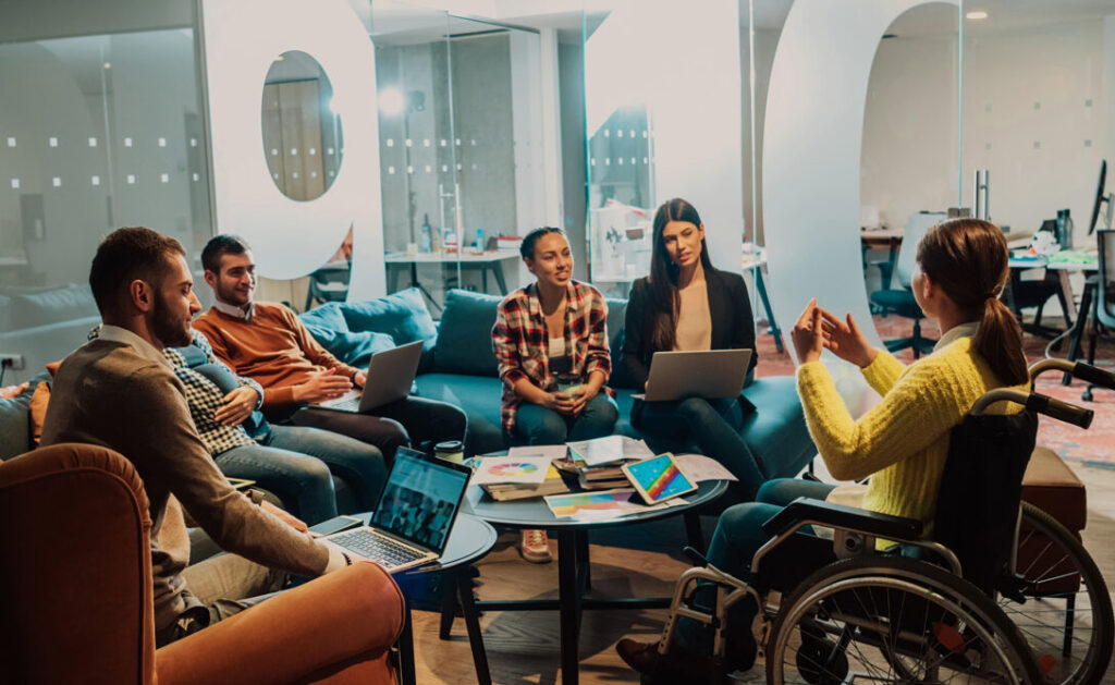 A group collaborating in a workspace, representing the use of ExperienceChangeⓇ at The Wharton School of Business.