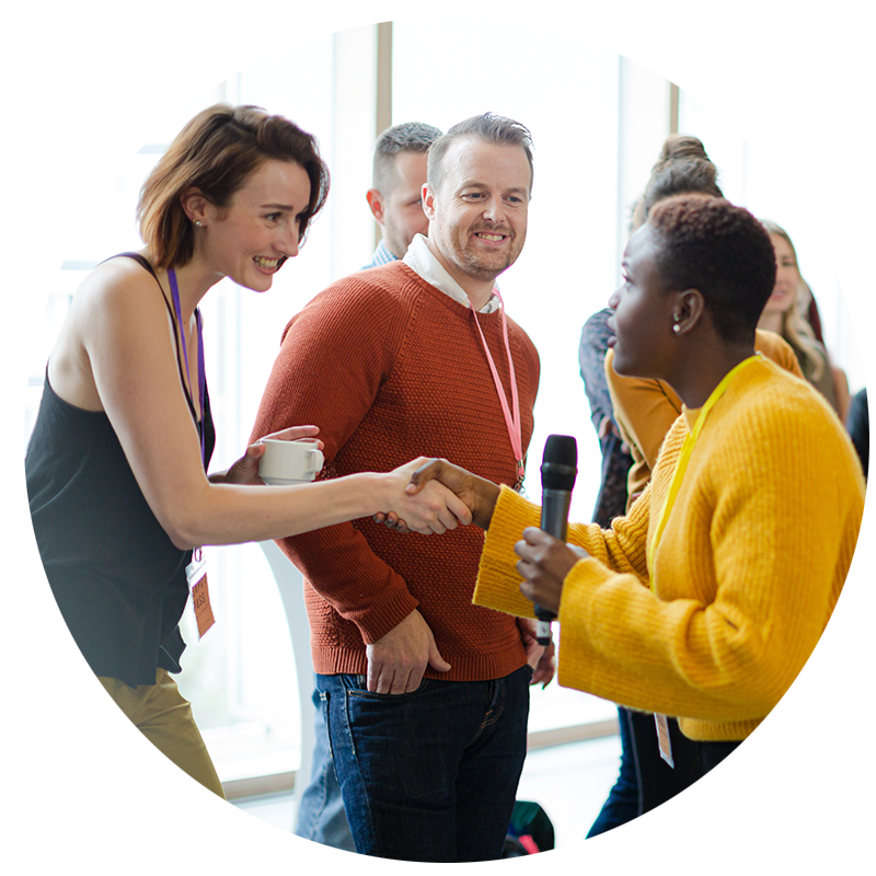 Facilitator interacting and answering questions from a community of varied people.